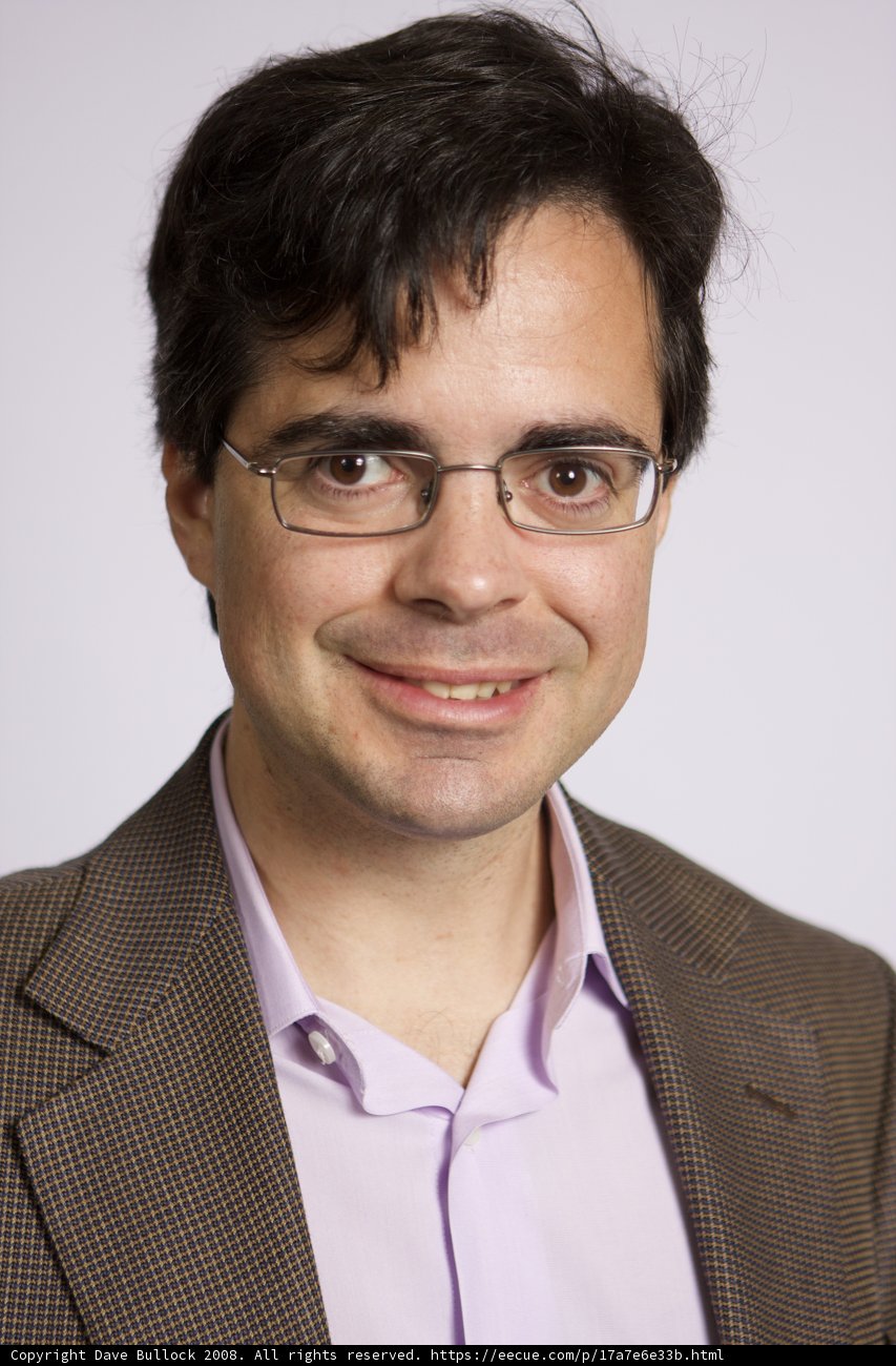 Smiling Man in a Suit Jacket and Glasses