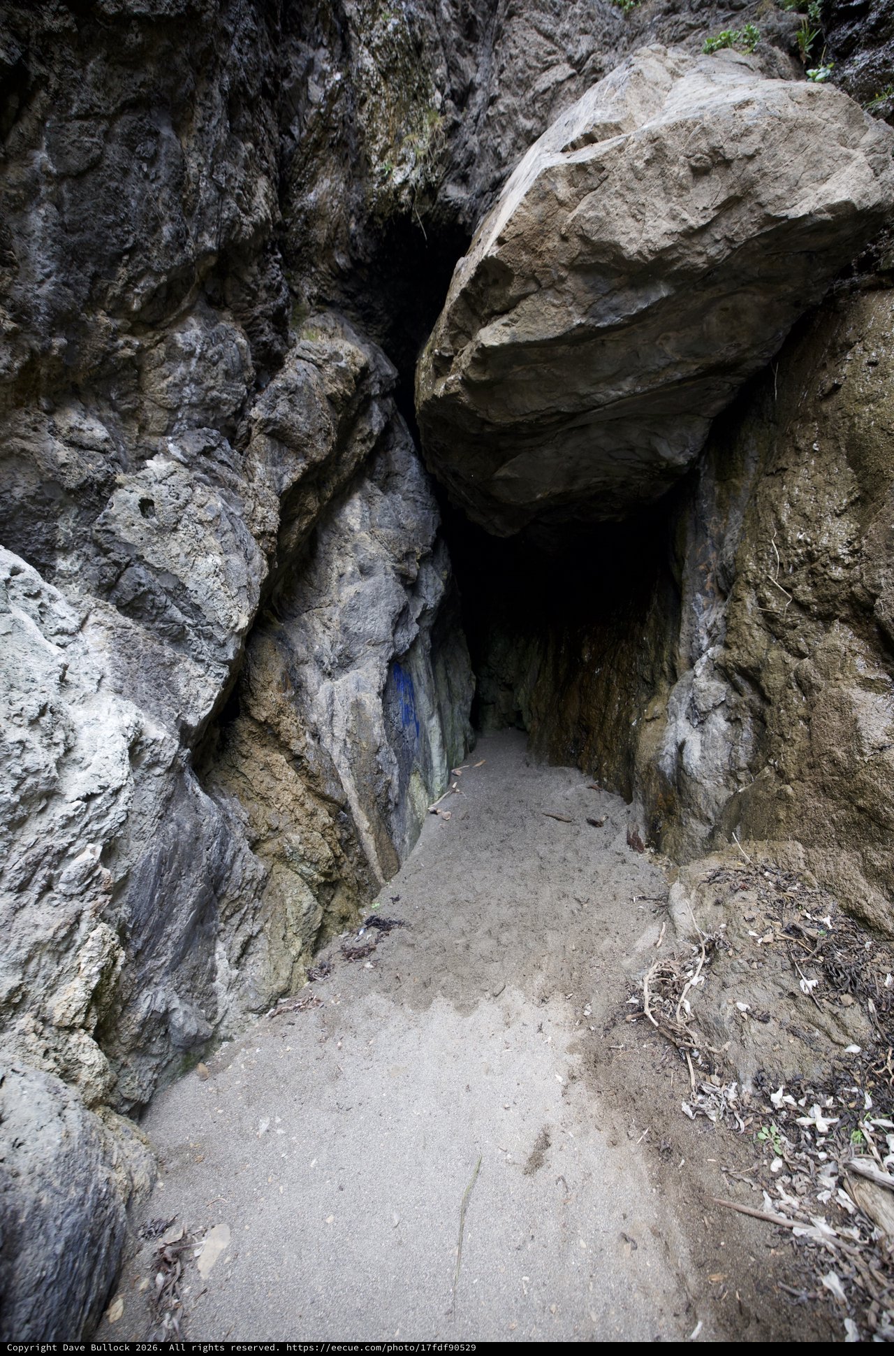 Dark Passage Into Ancient Rocky Cave Entrance
