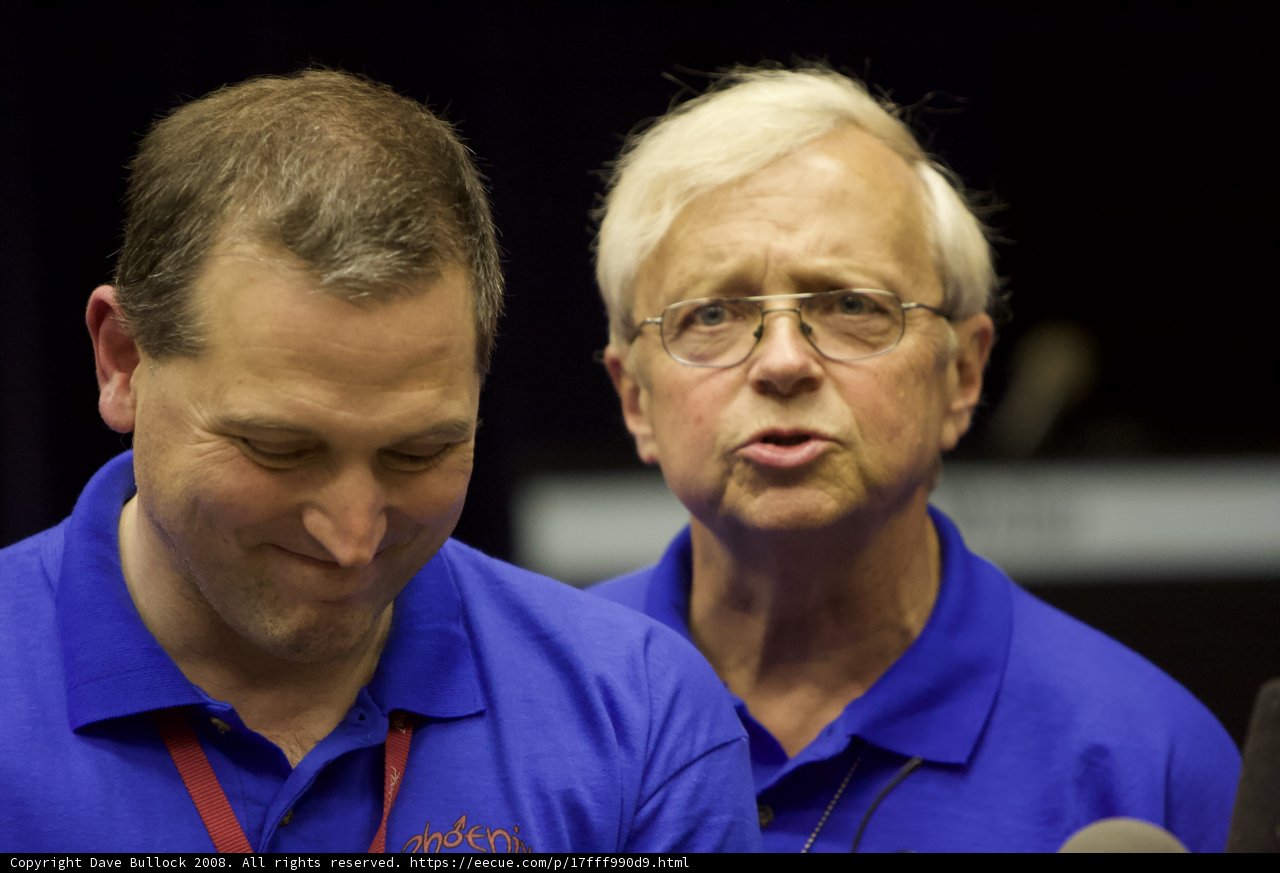 Conversing Men in Blue Shirts