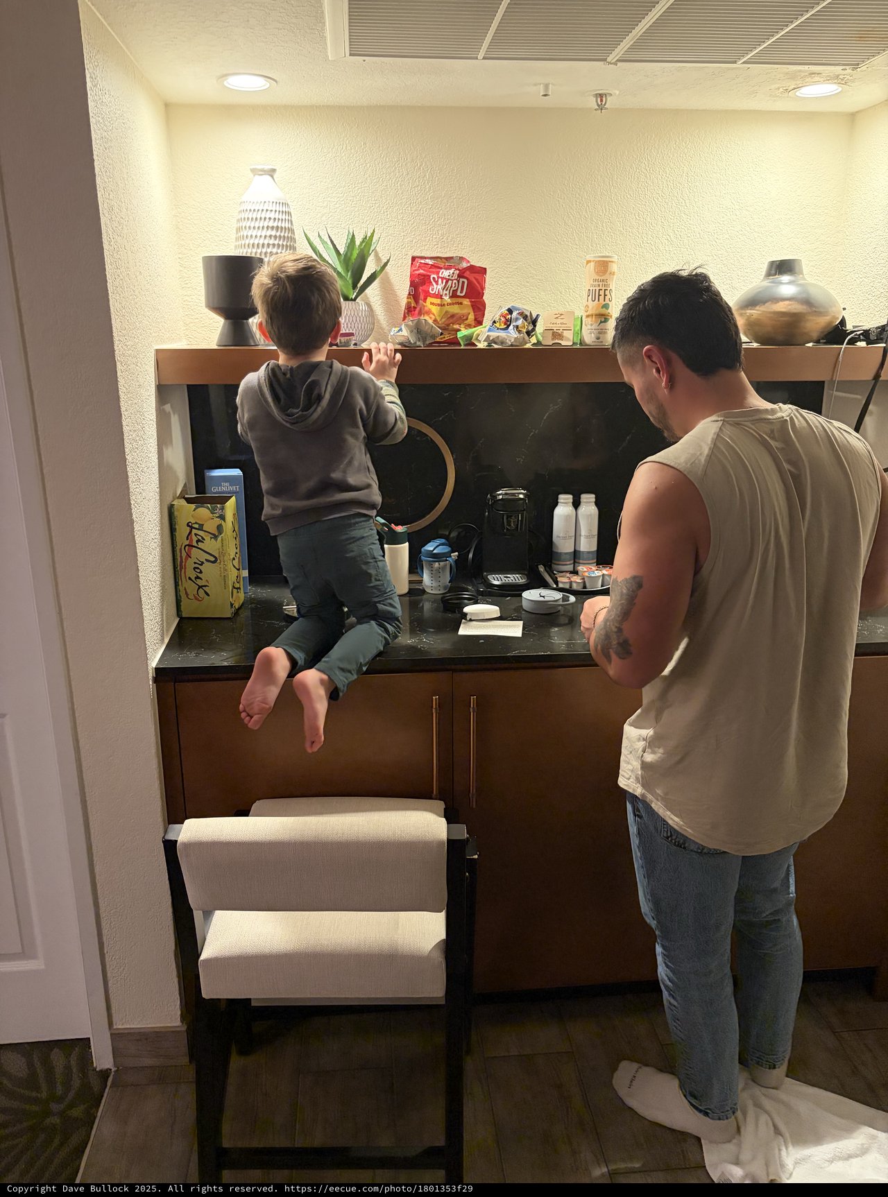 Father and Son Making Coffee Together in Modern Kitchen