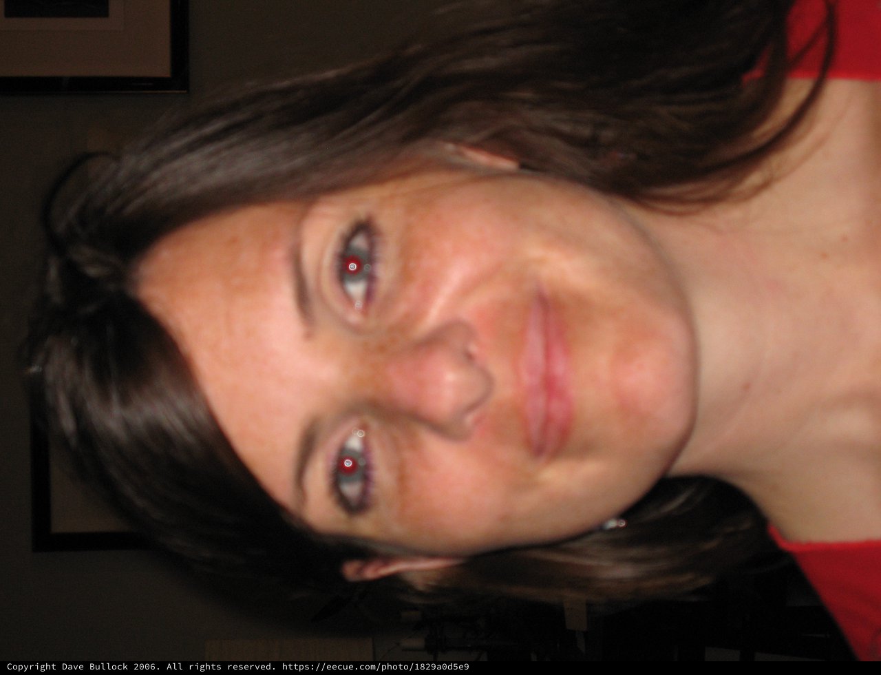 Smiling Woman with Red-Eye Effect in Warm Portrait