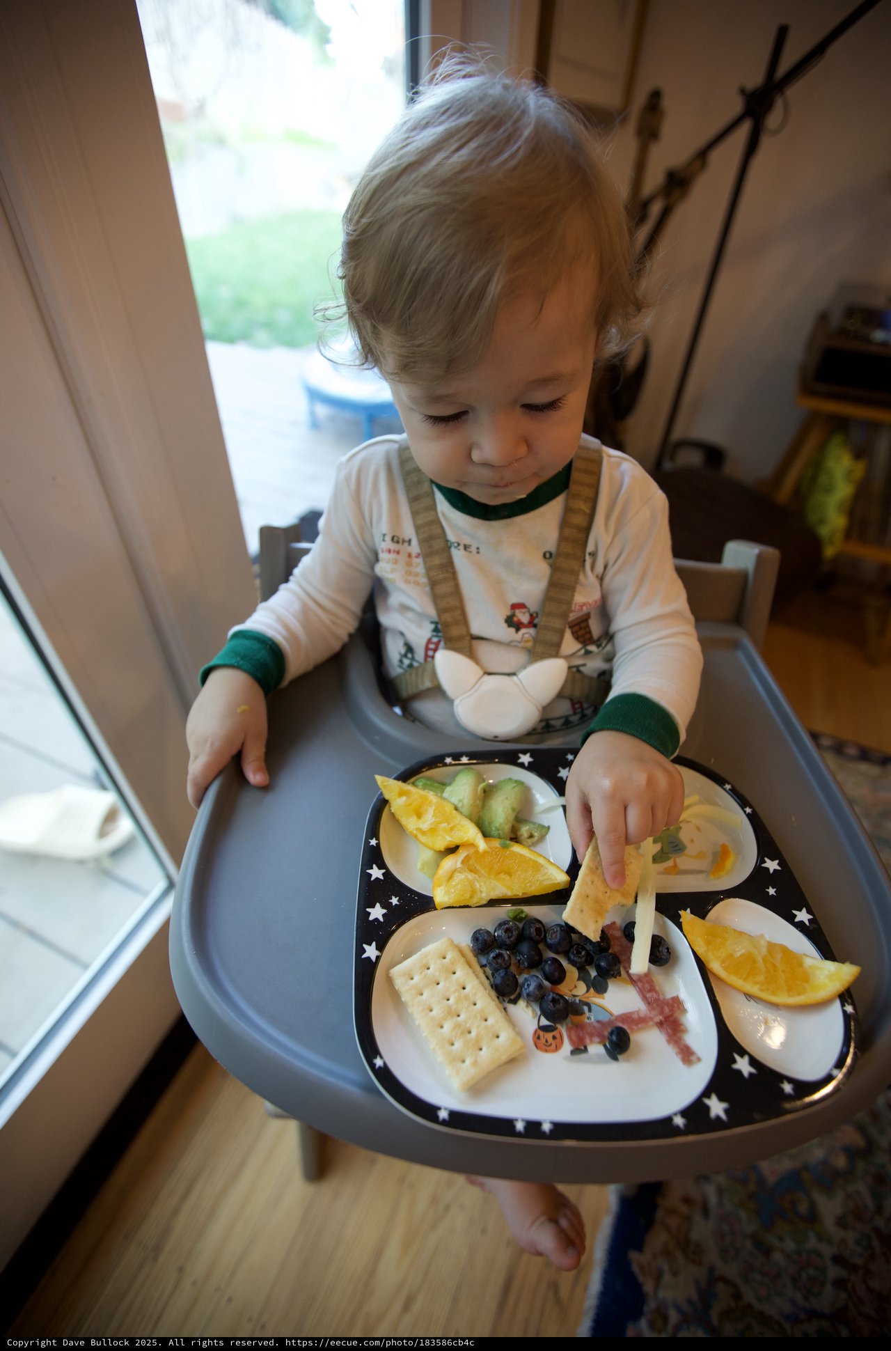 Toddler Enjoying Christmas Eve Breakfast at Home