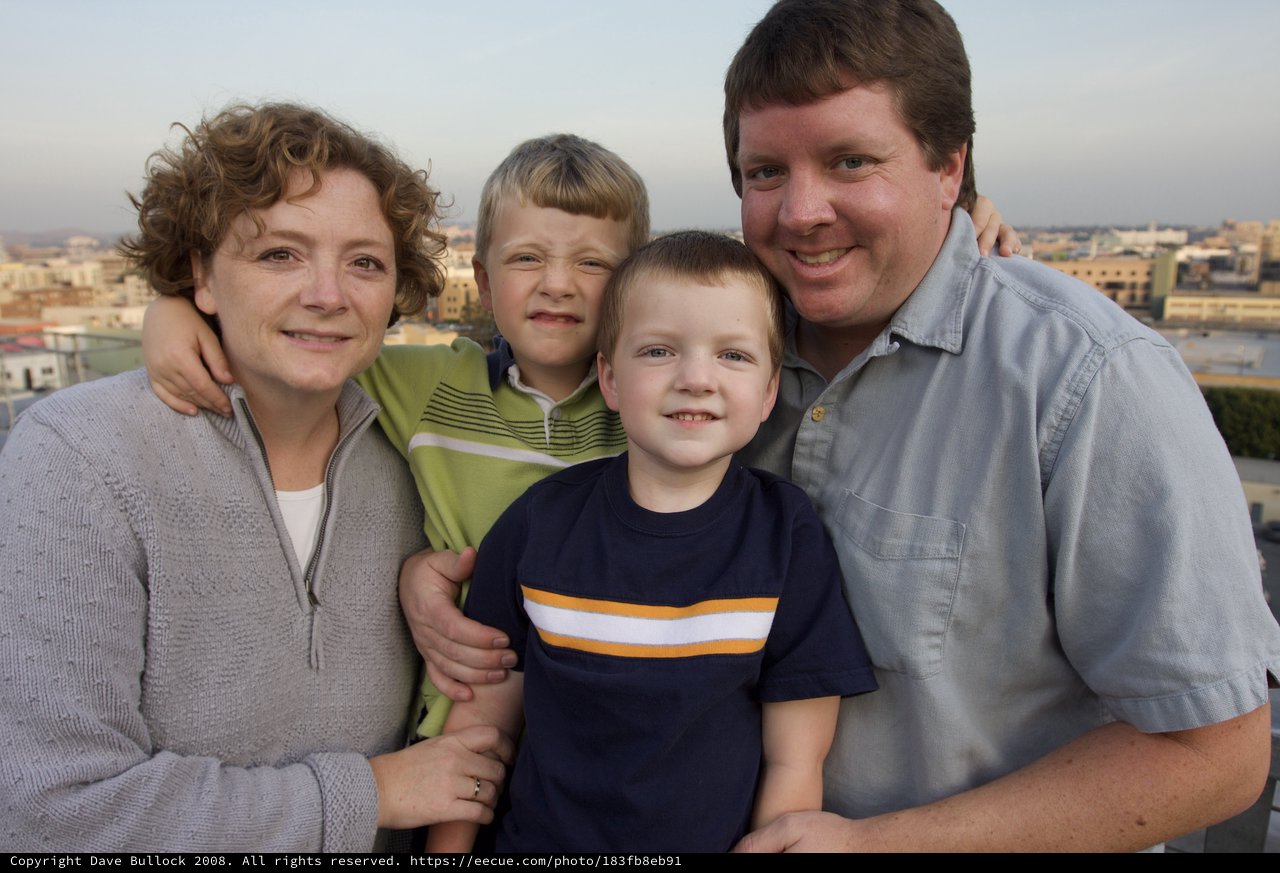 Happy Family Portrait on Rooftop at Dusk