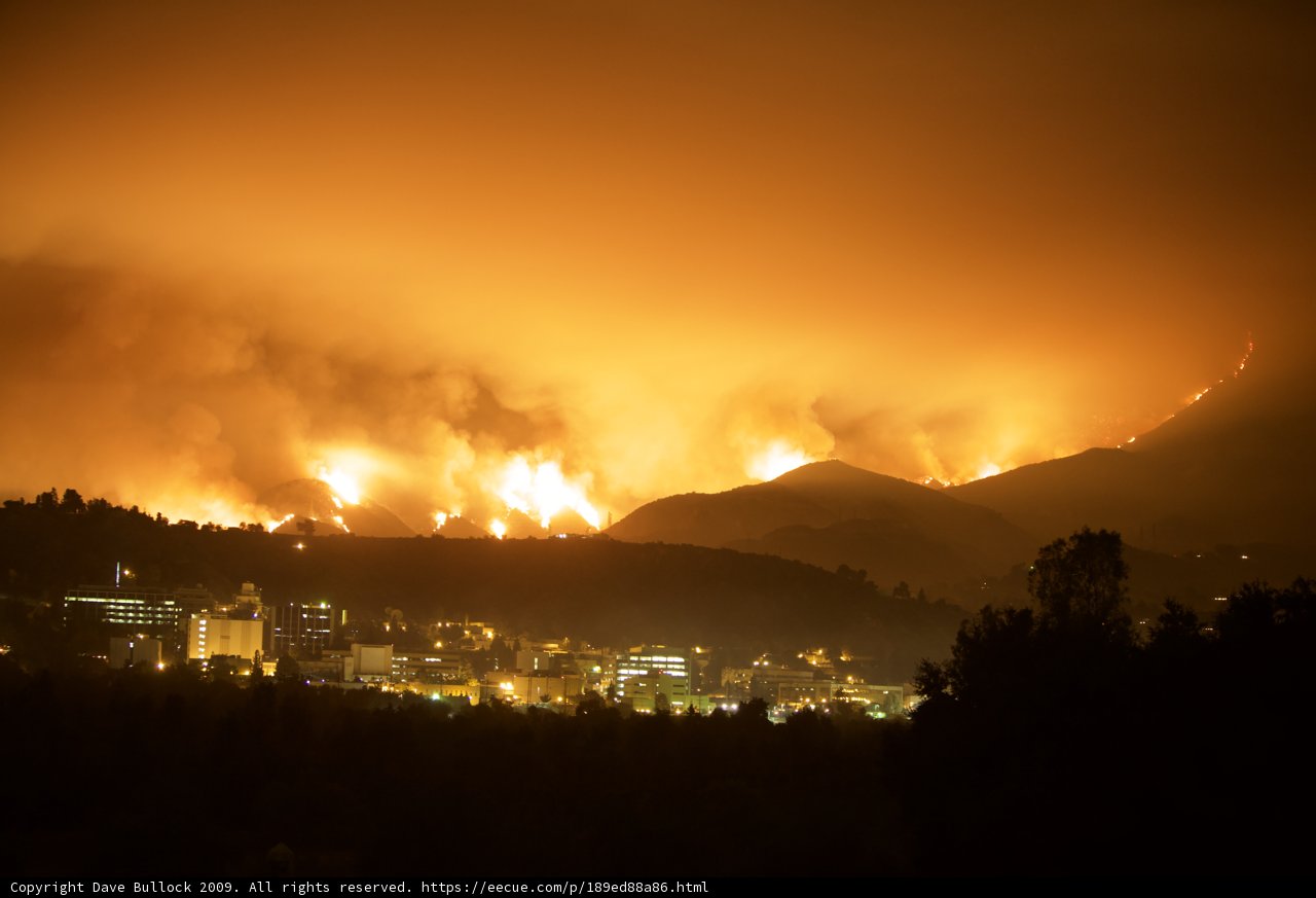Flames Engulf Mountain and Cityscape