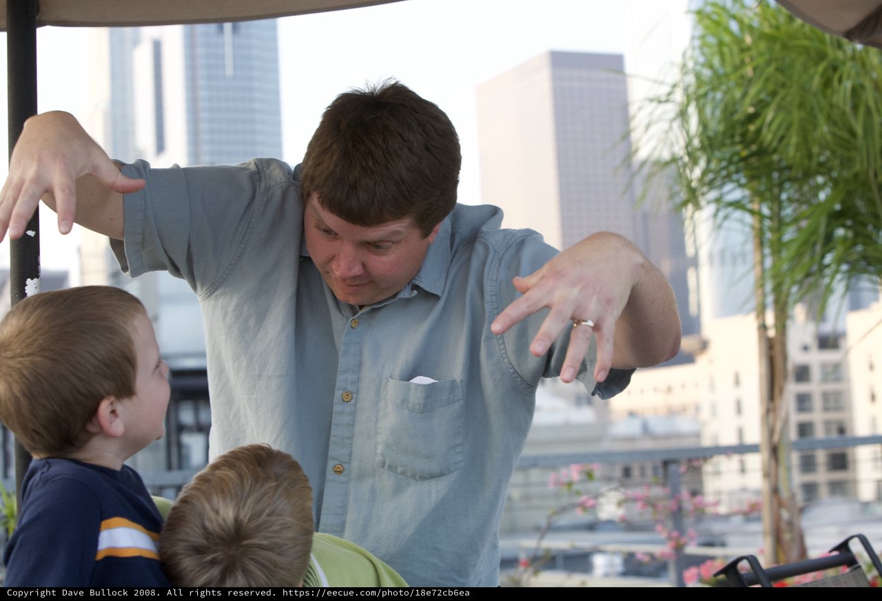 Father Entertains Kids with Animated Storytelling Outdoors
