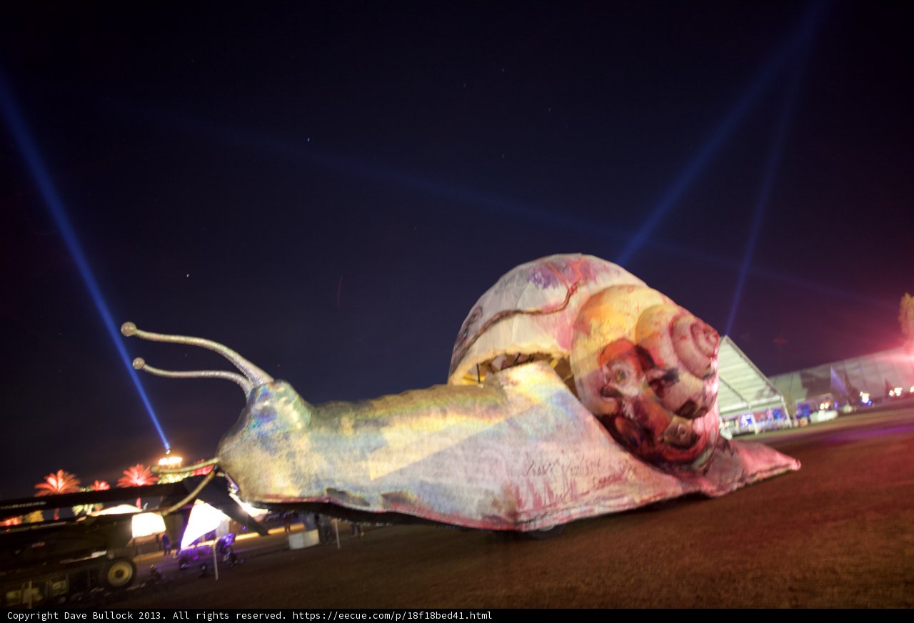 Glowing Snail Sculpture Shines in the Night Sky