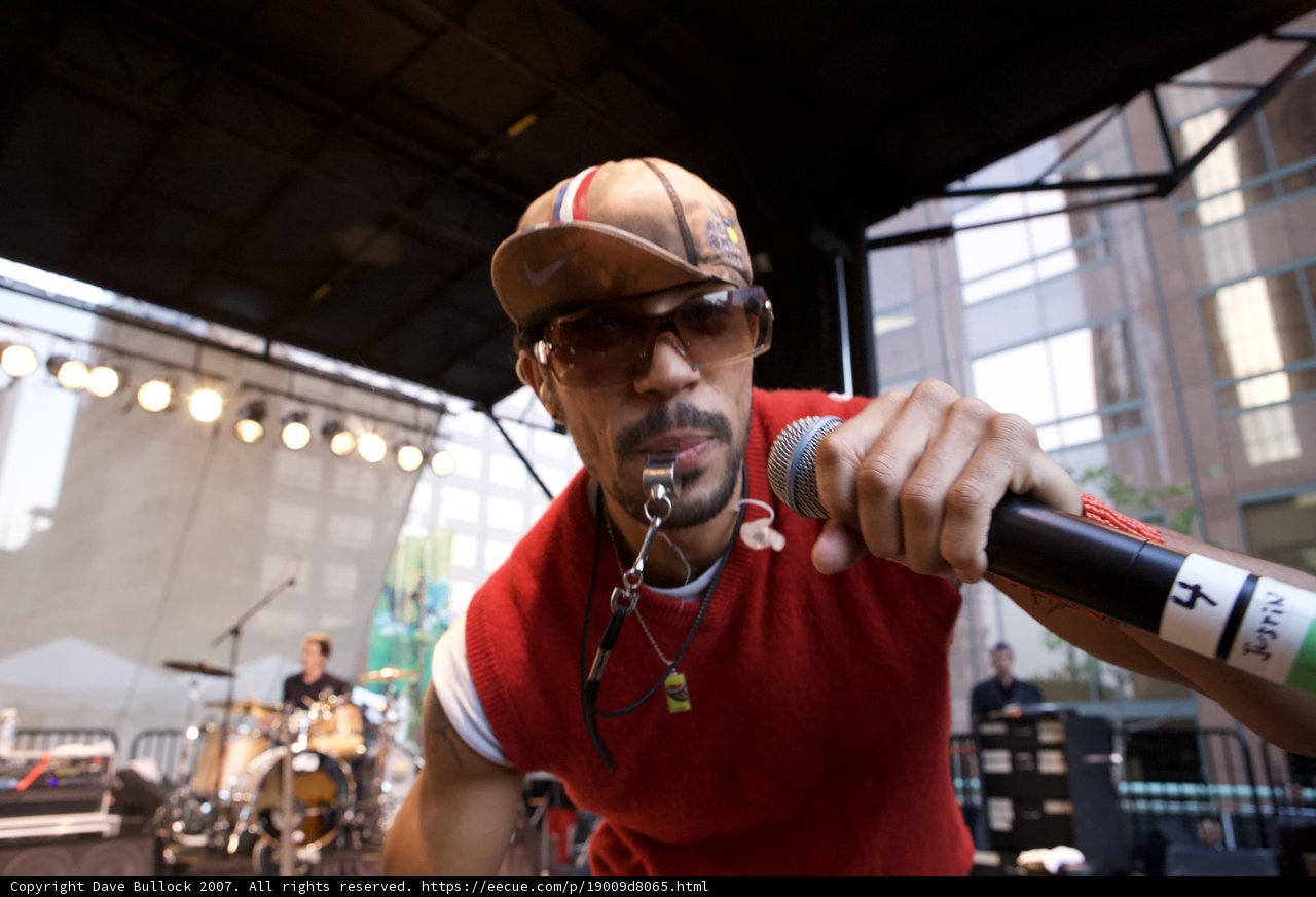 Red Shirted Man Rocks the Mic at Ozomatli Concert