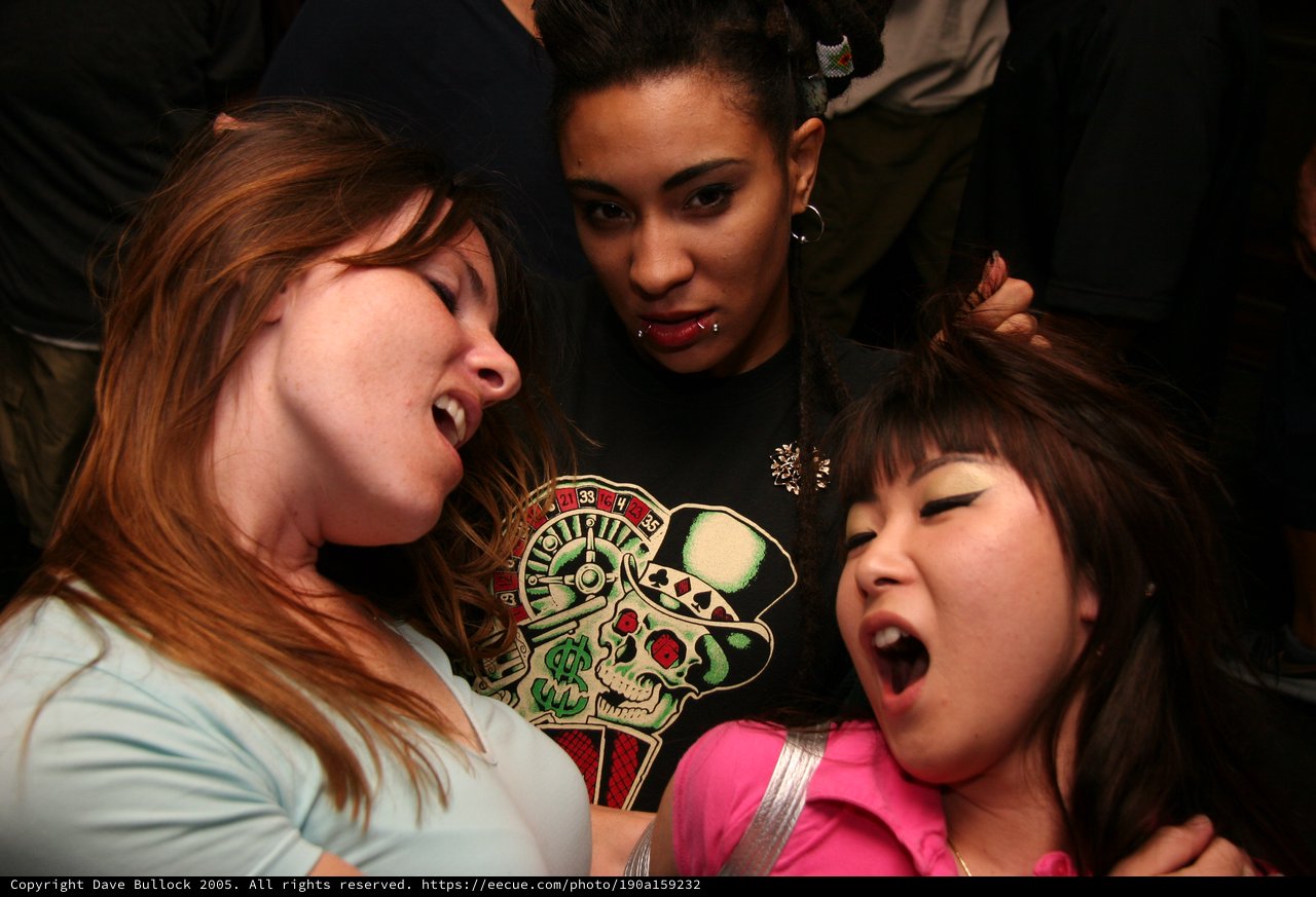 Three Women Caught in Intense Party Moment