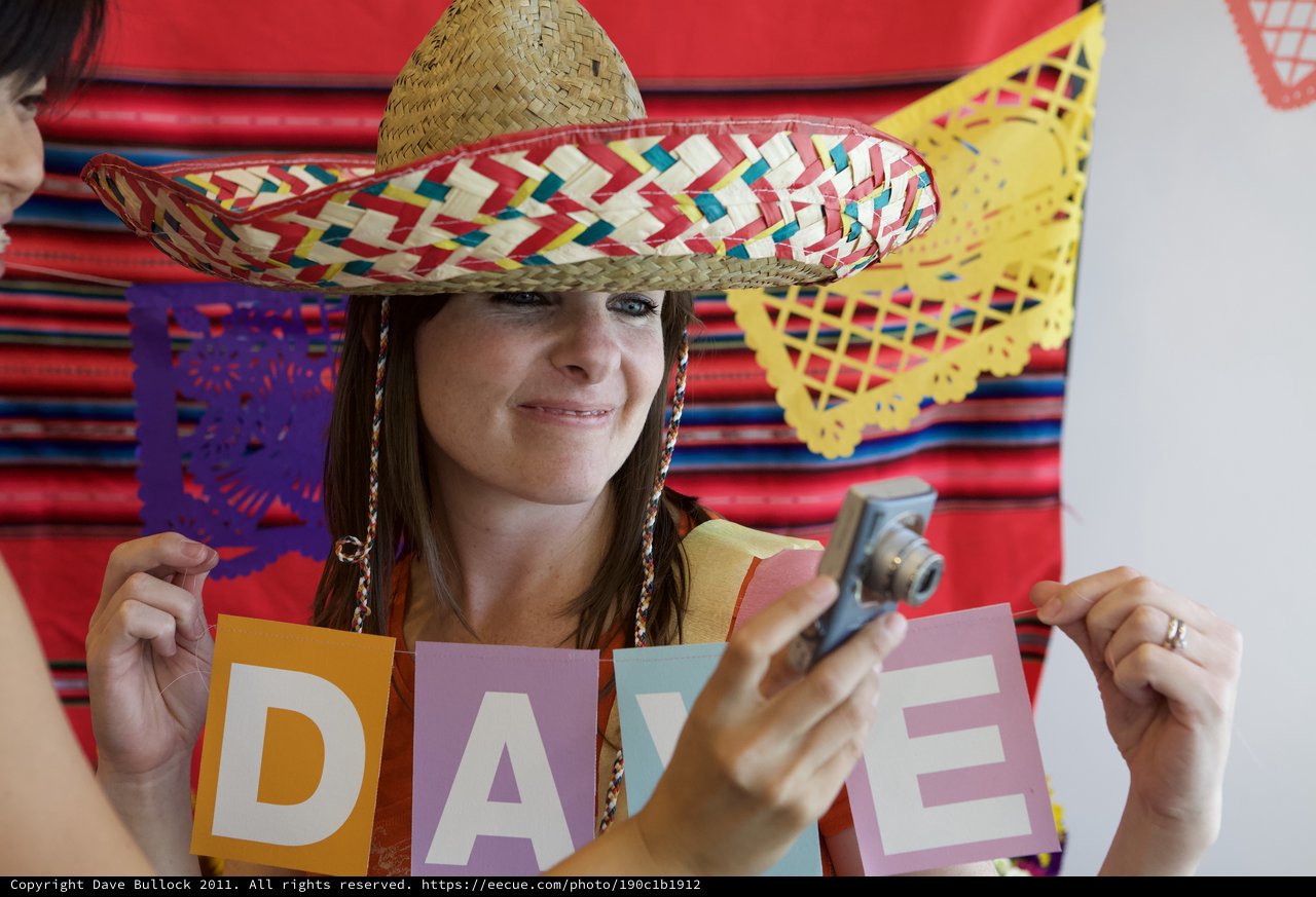 Fiesta Celebration Woman Holding DAVE Sign in Sombrero