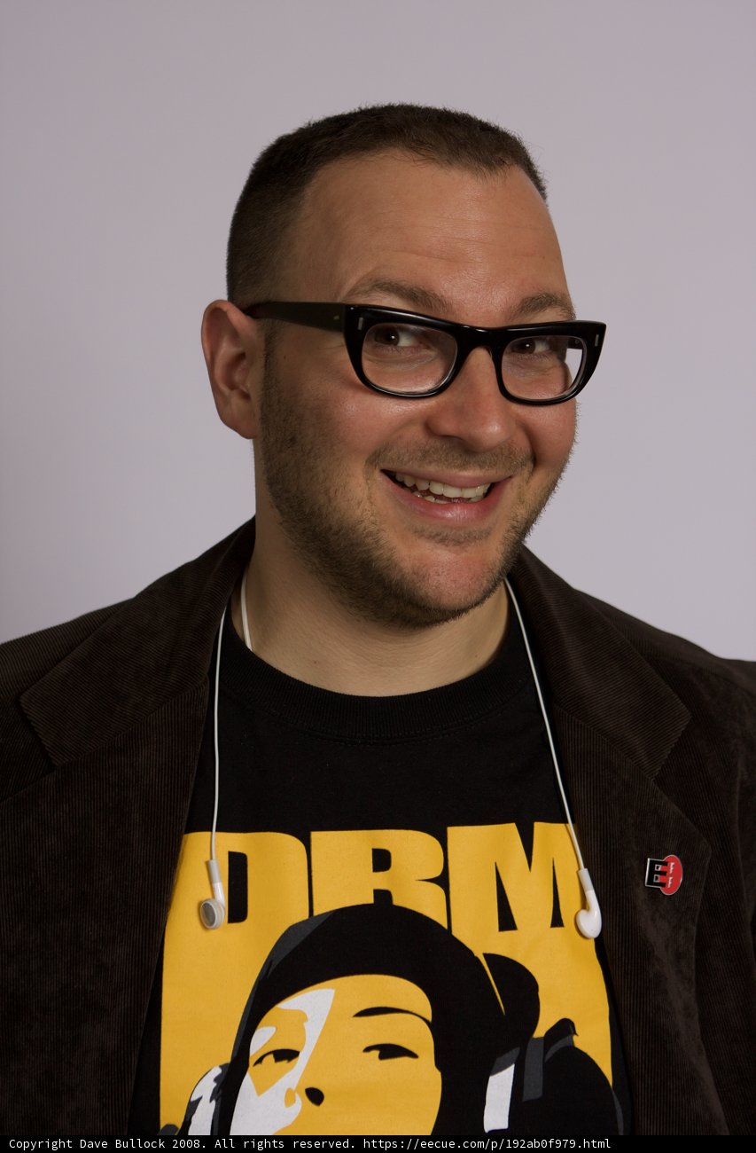 Smiling man in glasses and black jacket