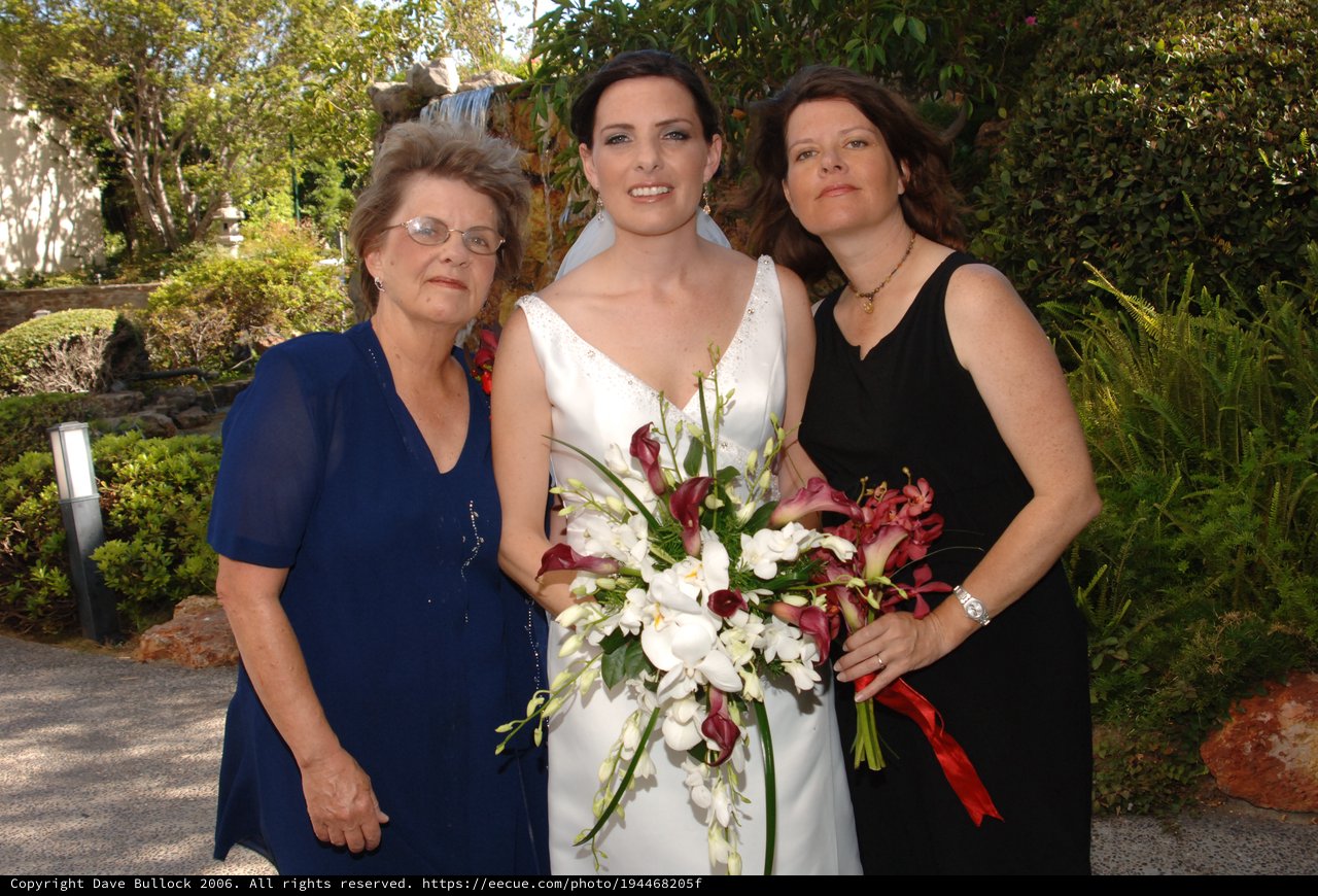 Bride Poses with Family at Garden Wedding