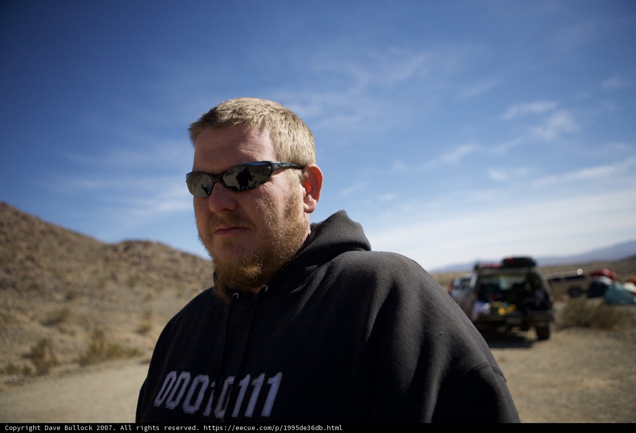 Man in a Hoodie and Sunglasses Embracing the Desert