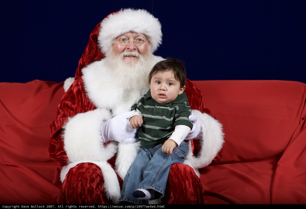 Santa Claus and Child on Red Couch