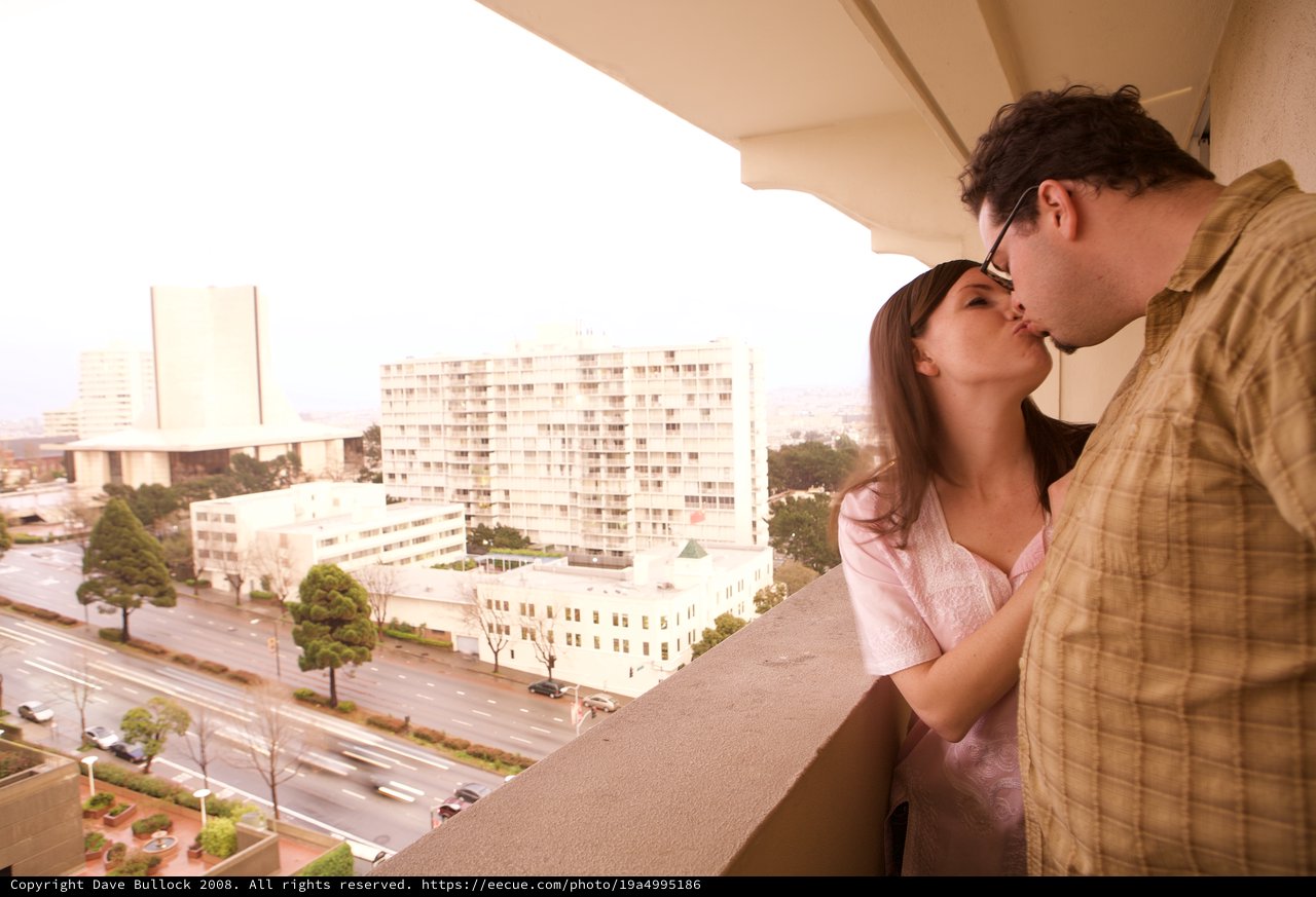 Romantic Balcony Kiss Overlooking City Skyline