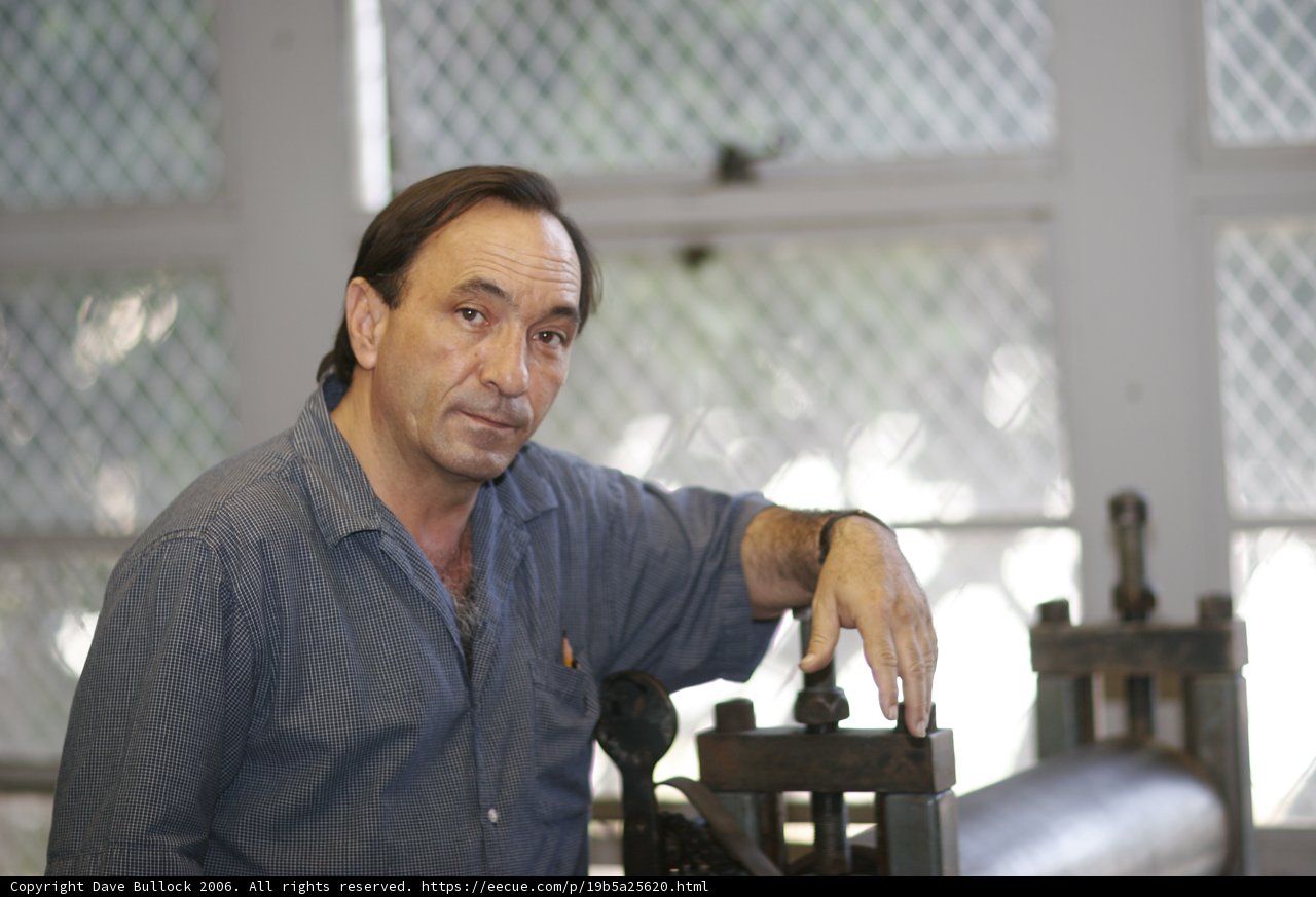 Contemplative Man Resting on Wood Machine