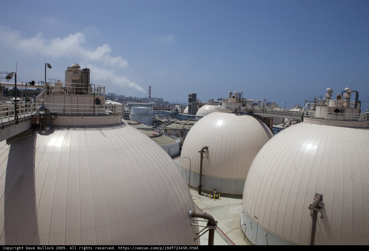 Large White Silos Against Blue Sky