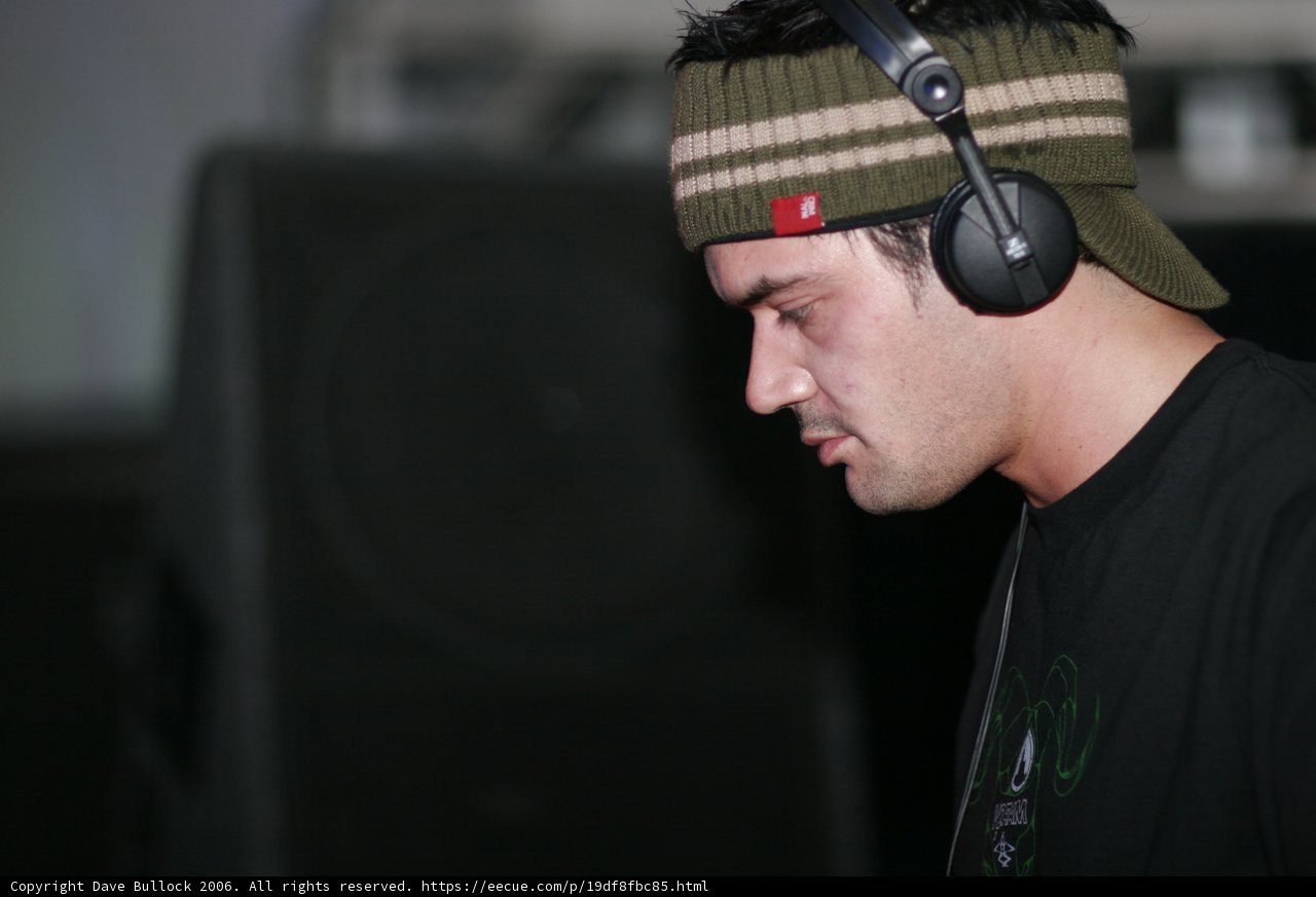 Black Shirted Man Listening to Music