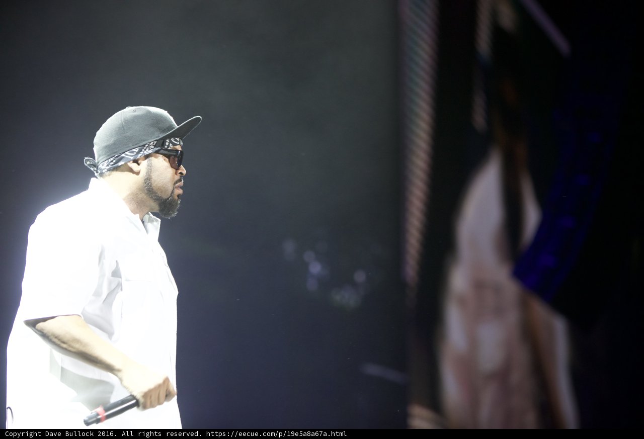 Man in White Hat and Shirt Performing on Stage