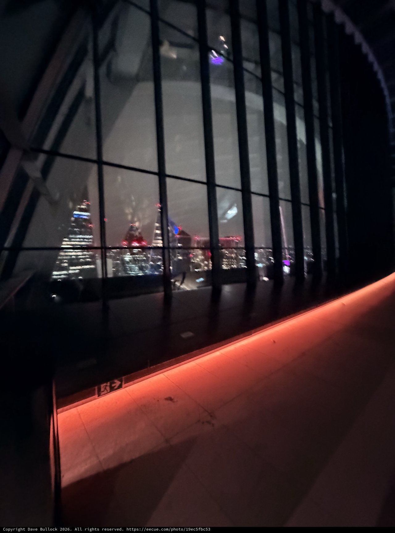 Night View of London Skyline Through Modern Glass Architecture