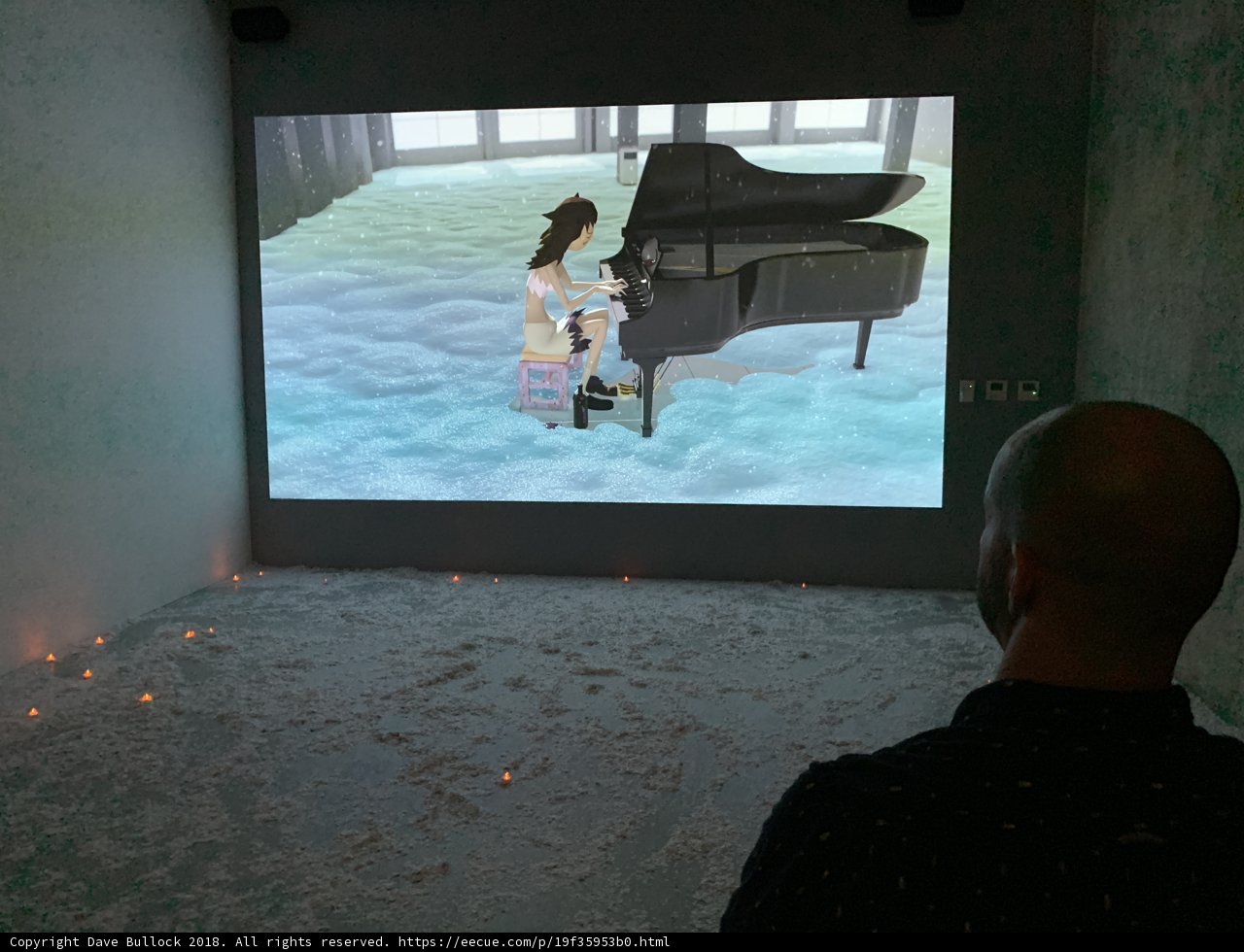 Man Enthralled by Piano Performance on Screen