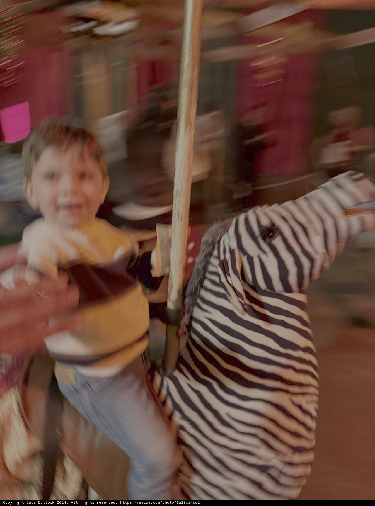 Children Enjoying Blurry Carousel Ride Motion
