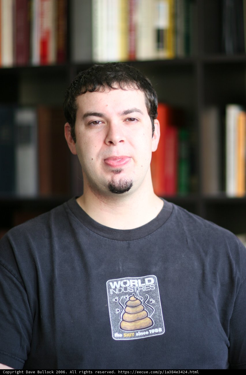 Man Standing in Front of Bookshelves