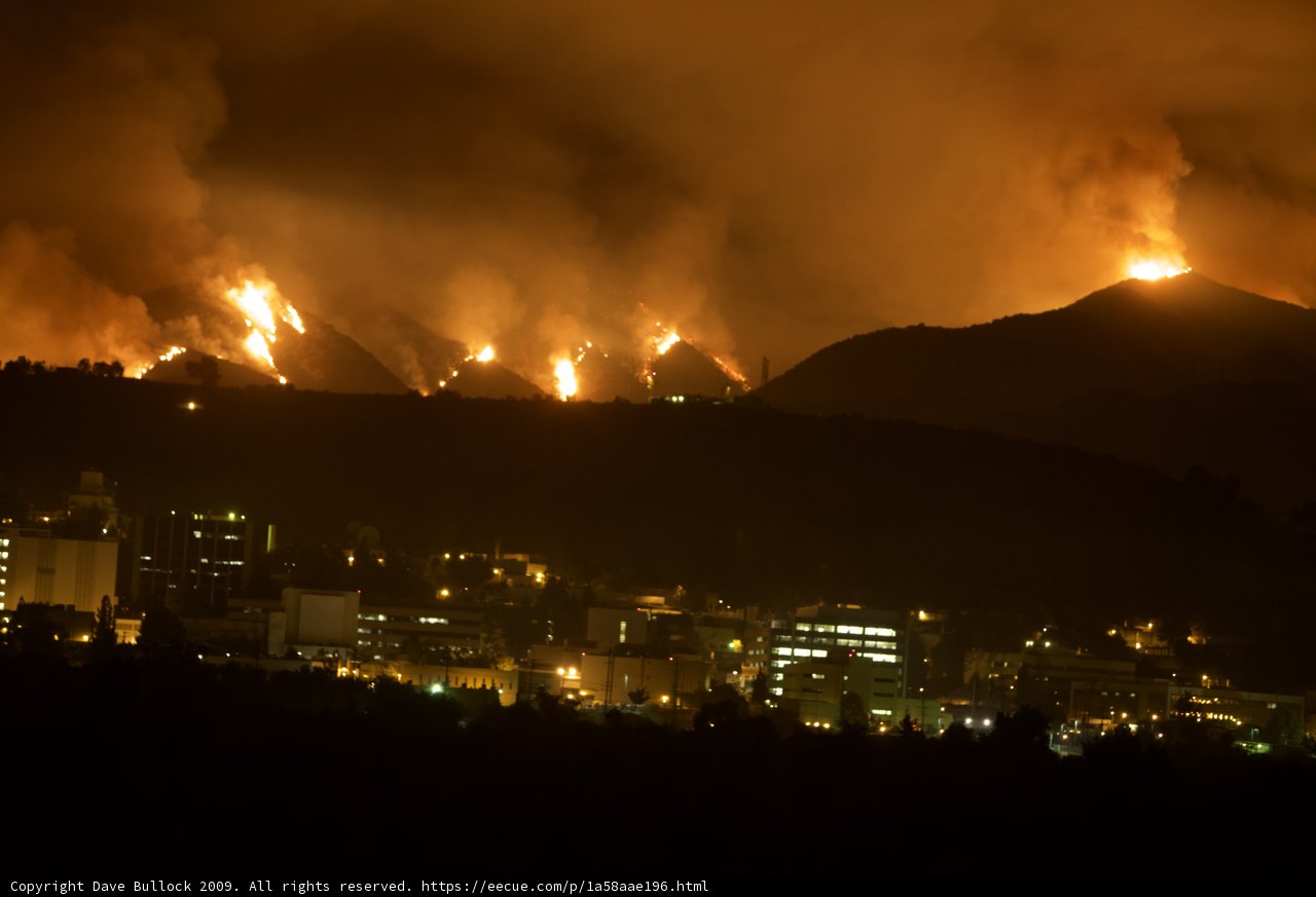 Flames Loom Over City Skyline