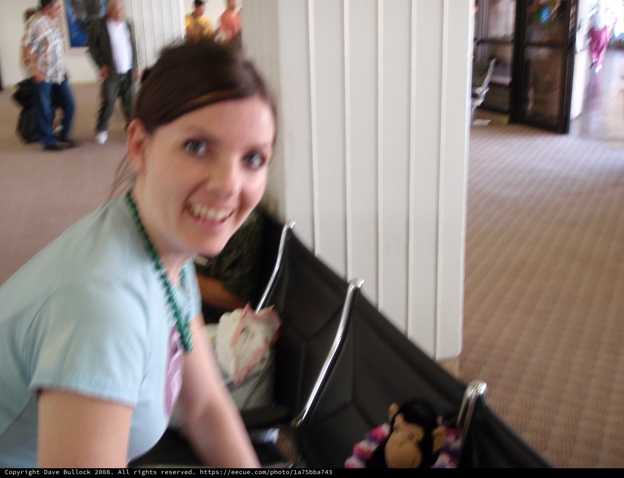 Smiling Woman With Stroller at Indoor Event
