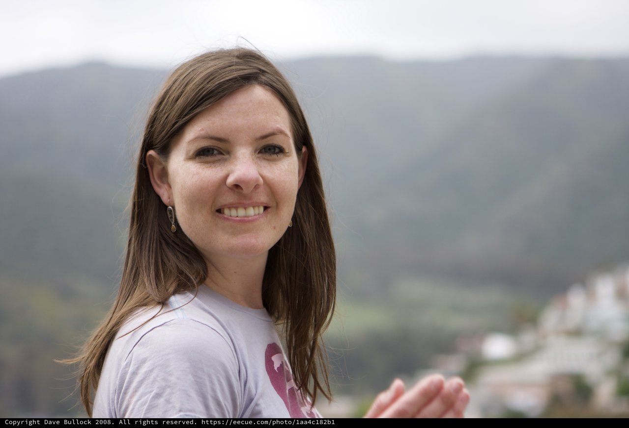 Smiling Woman Overlooking a Mountain Village