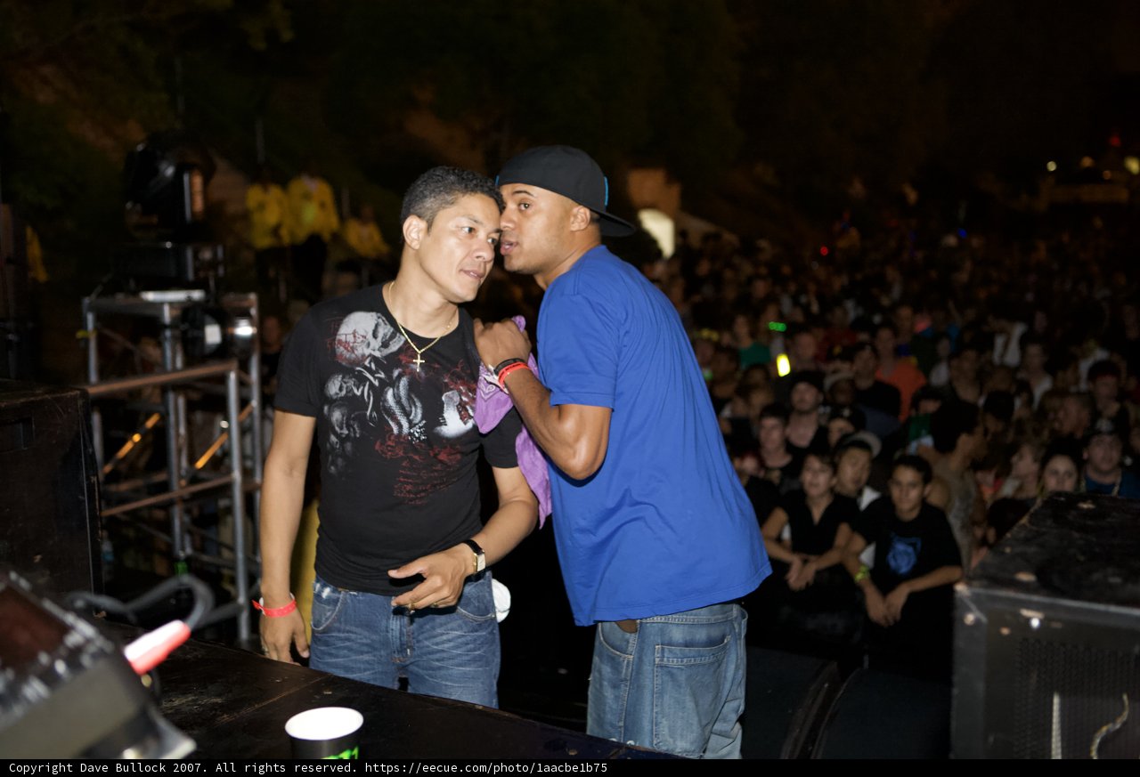 Two Men Grooving to Dynamite MC's Performance