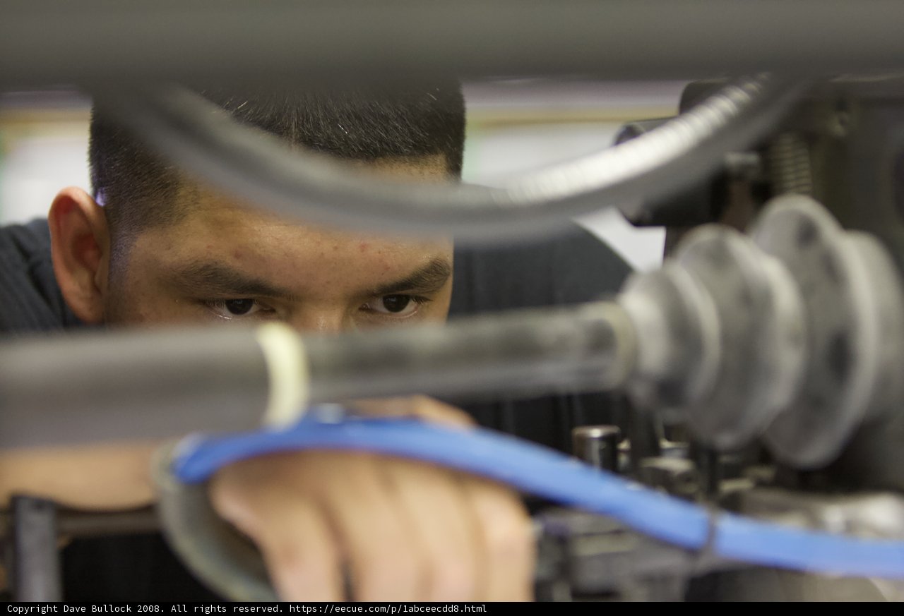 Factory Worker Fine-Tuning Machinery