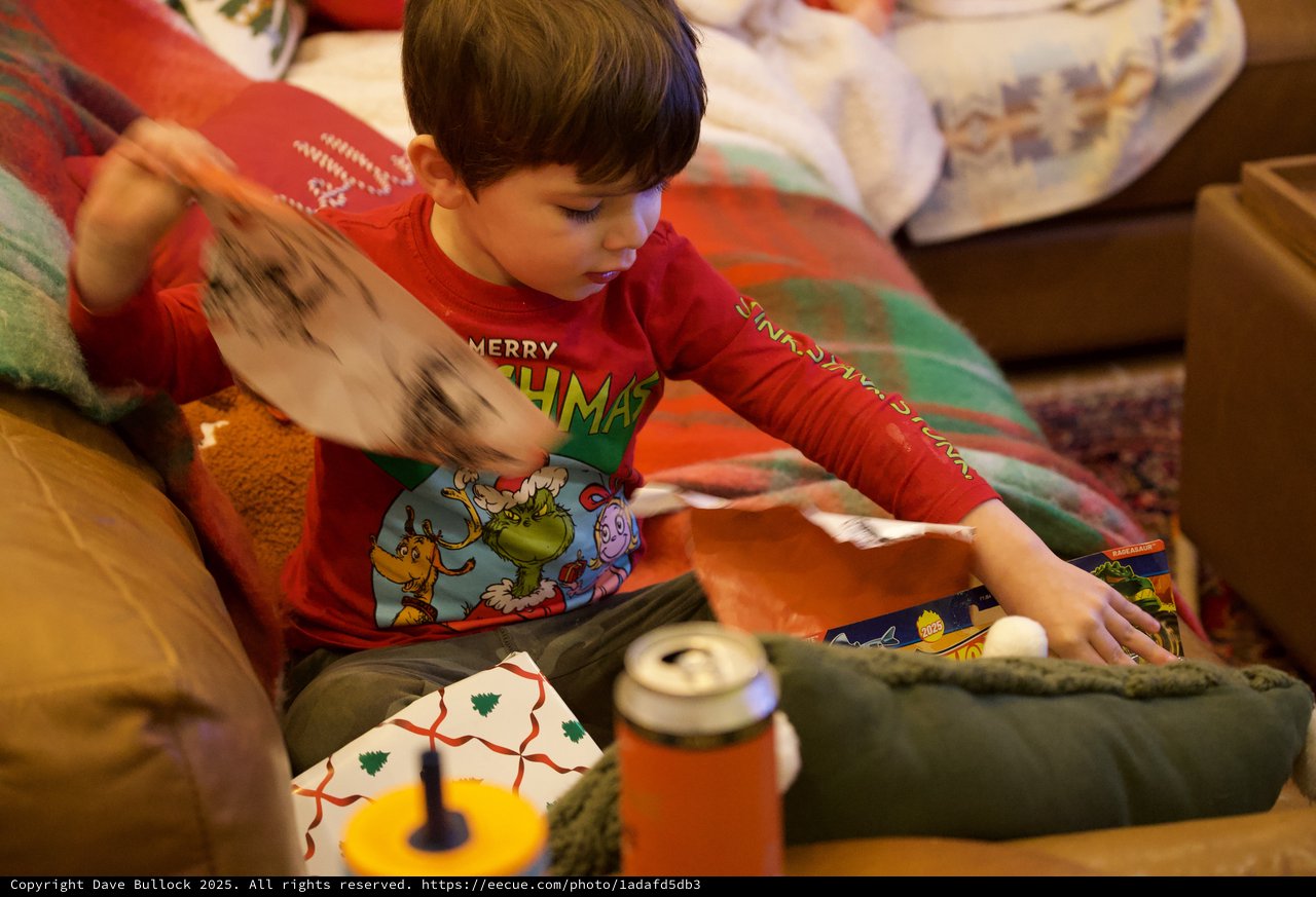 Child Opening Christmas Presents on Christmas Morning