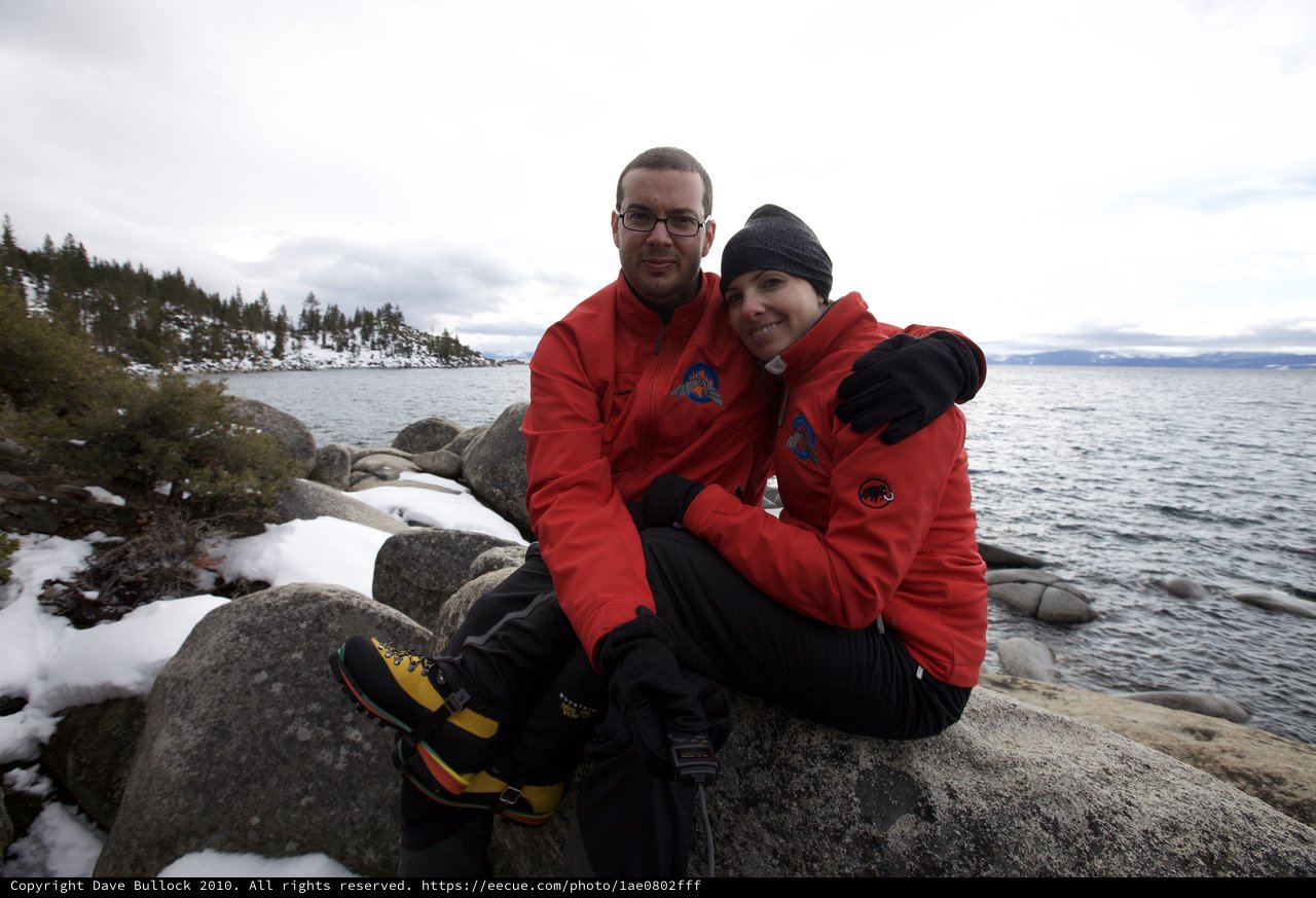 Couple Embracing by Snowy Lake Tahoe Shore