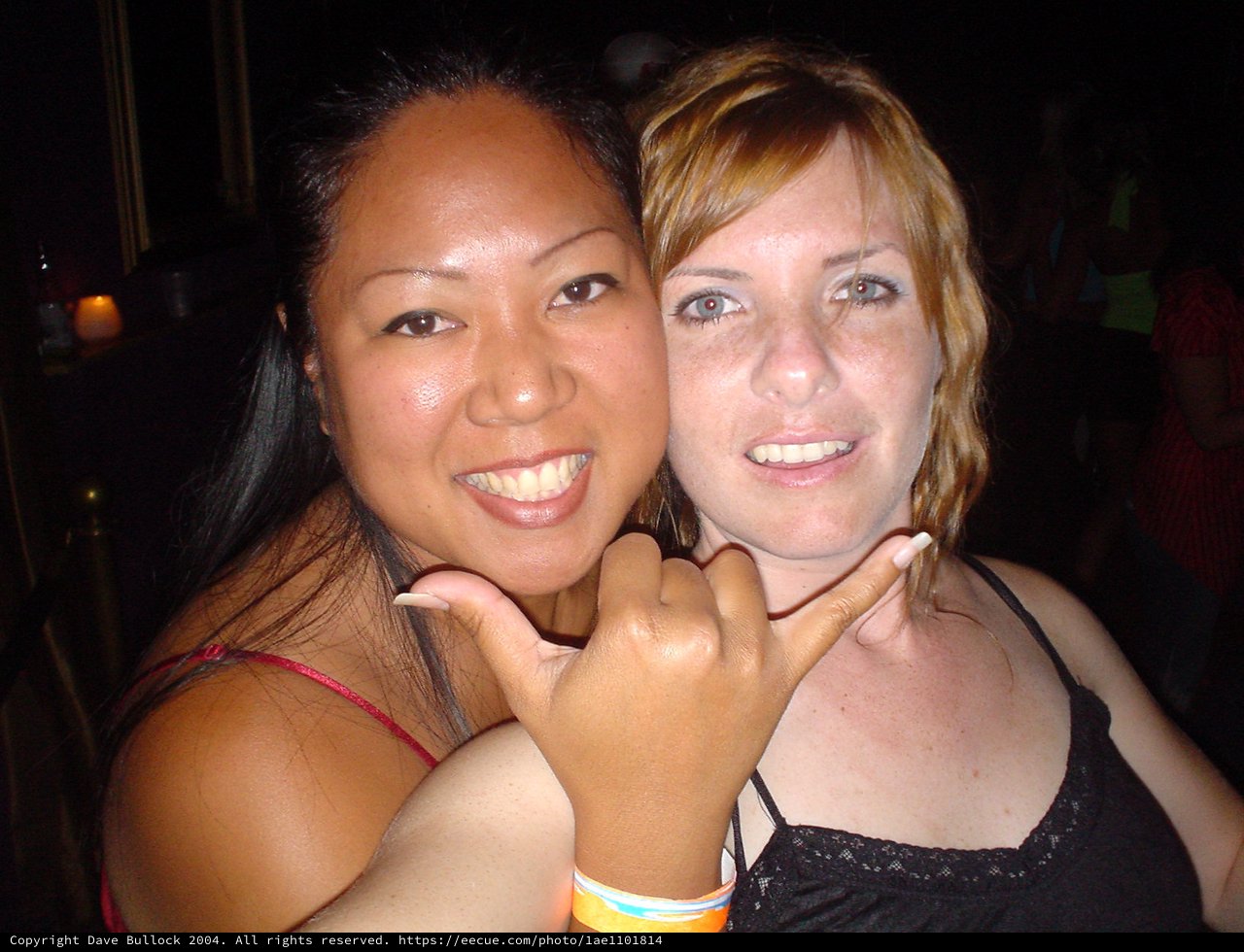Two Friends Smiling at a Nightclub Party
