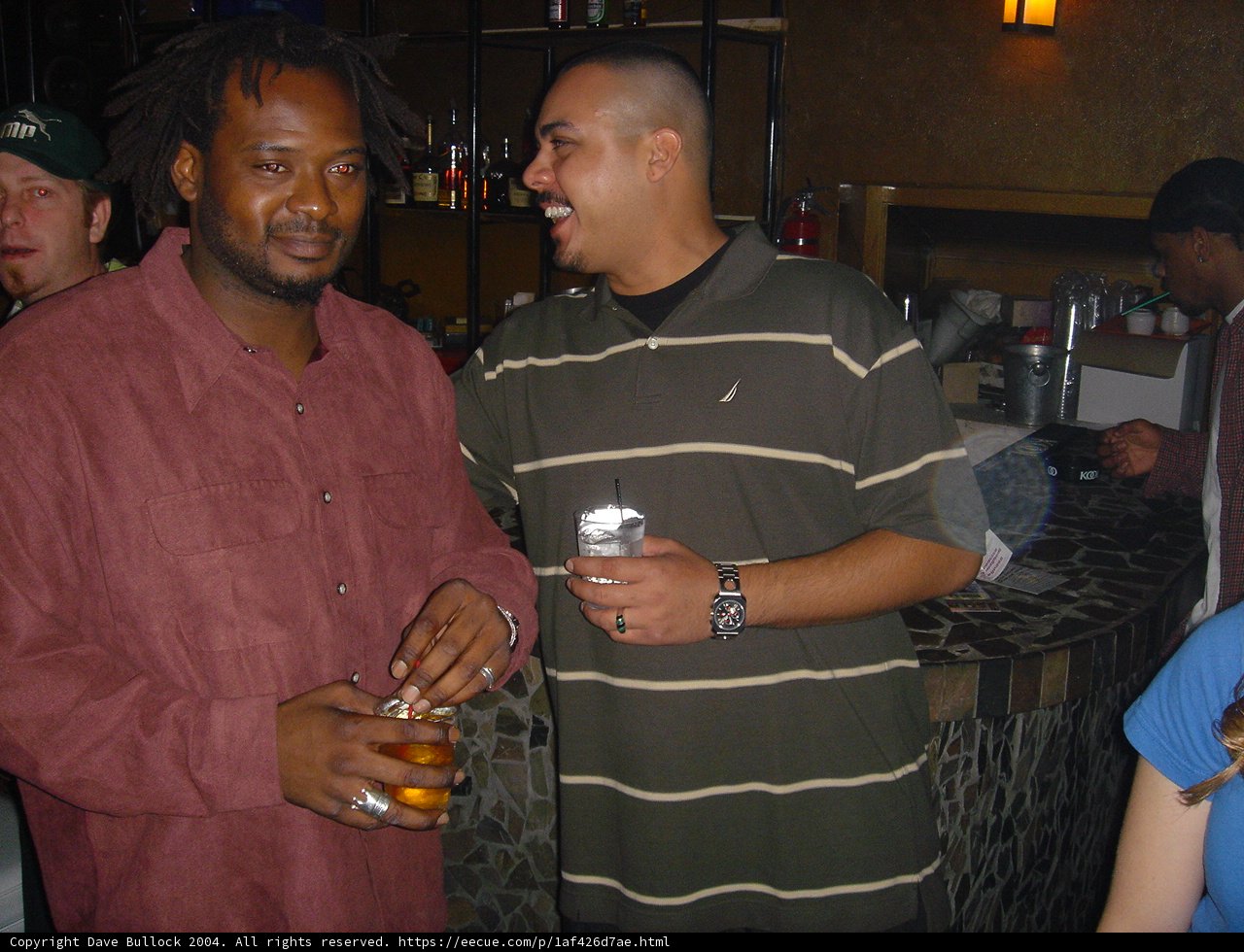Red Shirted Man Enjoying Drinks with Friends at the Bar