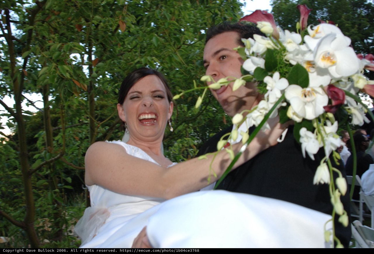 Joyful Bride Carried by Groom at Outdoor Wedding