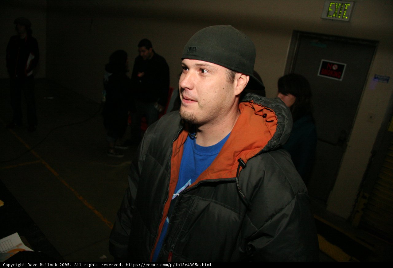 Fashionable Man in Black Jacket and Blue Hat