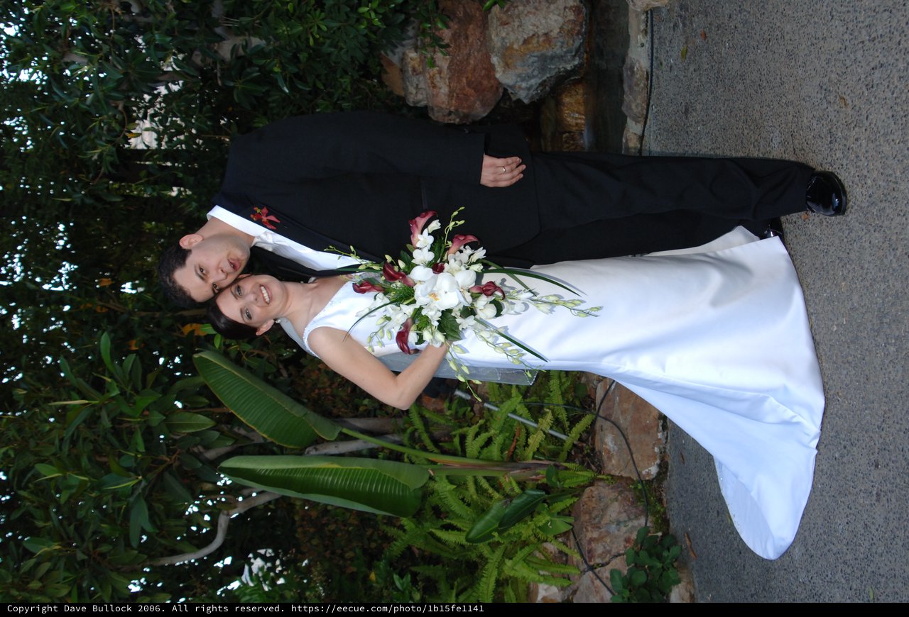 Newlyweds Pose in Lush Garden Setting