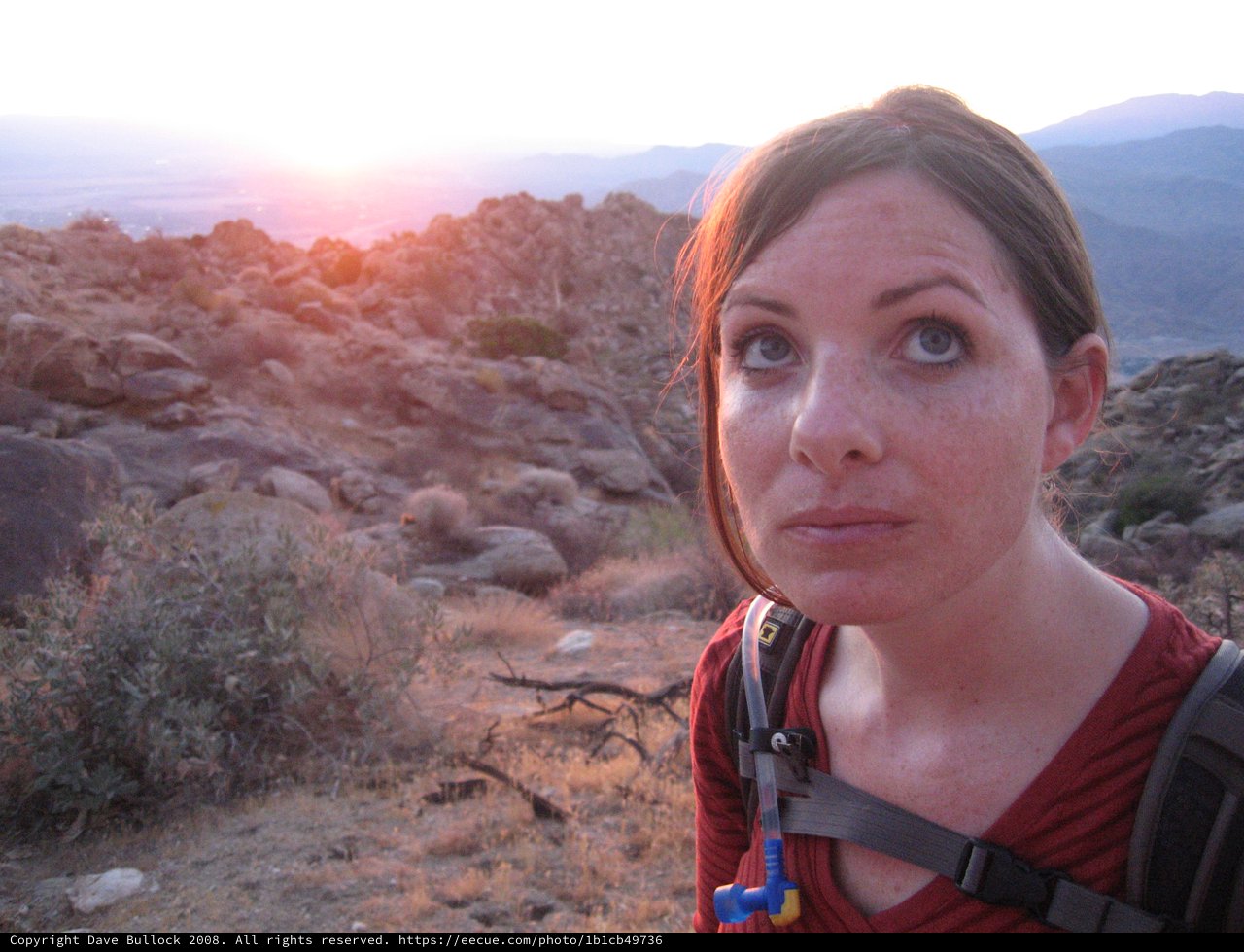 Hiker Pauses at Sunset on Rocky Desert Trail