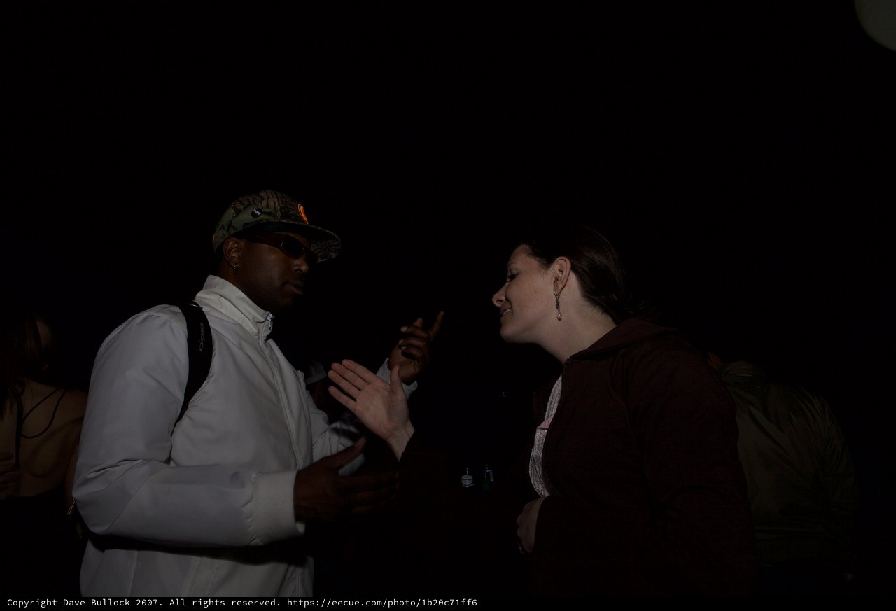 Animated Conversation Between Two People at Night Event