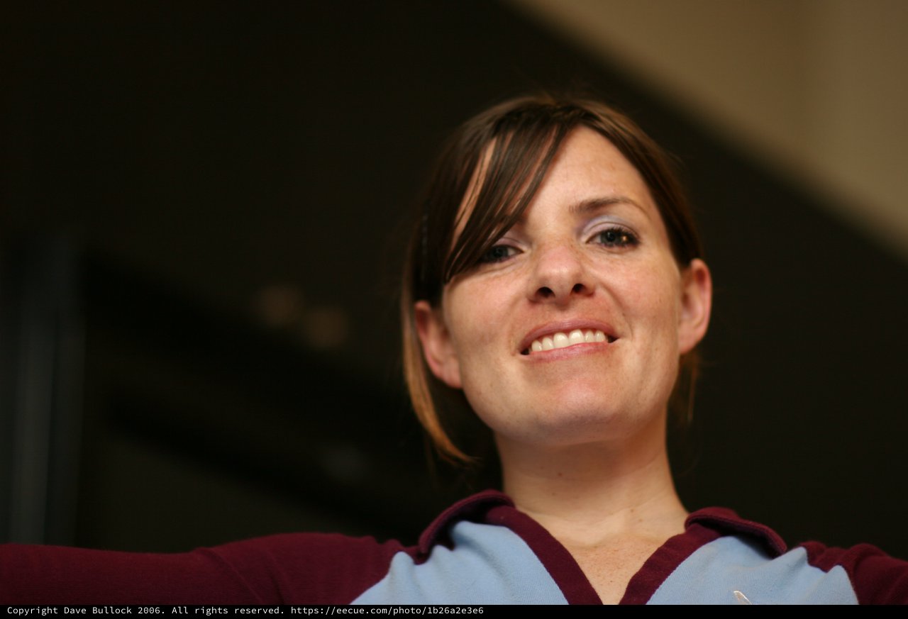 Woman in Burgundy and Blue Smiling Warmly