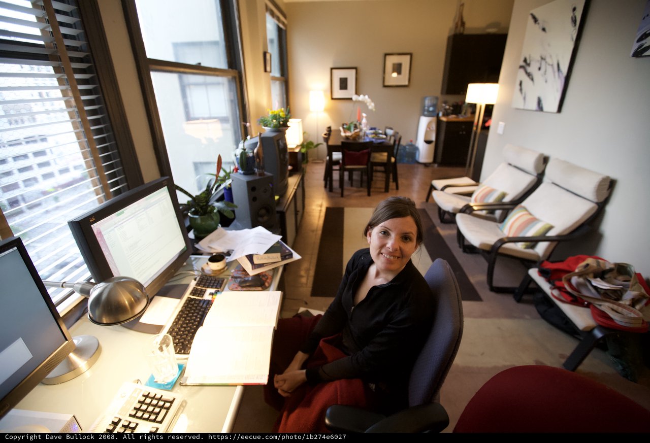 Woman Smiling at Home Office Desk Setup