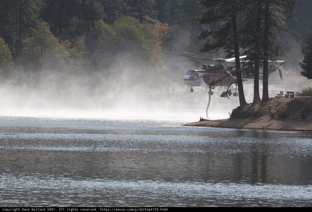 Helicopter Spraying Water on Lake