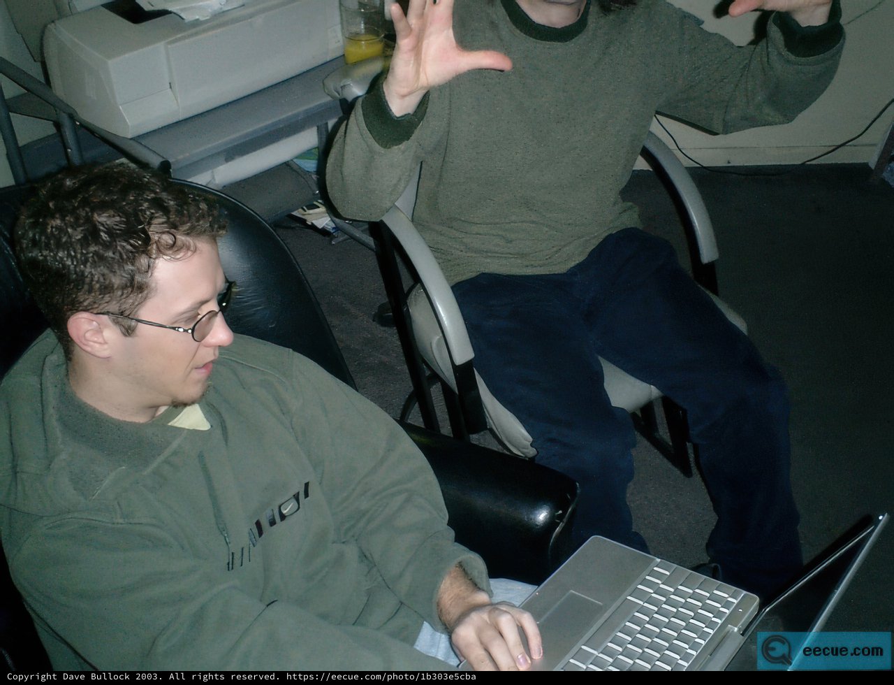 Green Sweatered Man Working on Laptop