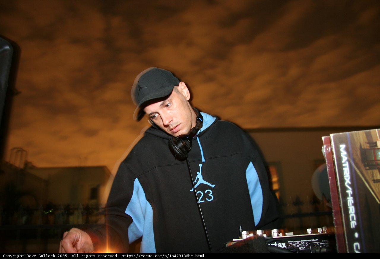 DJ S Entertains the Crowd in a Classic Baseball Cap