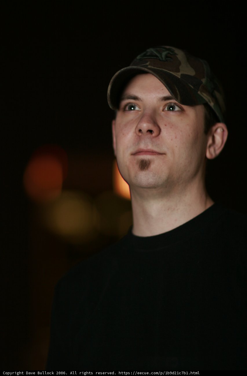 The Man in Black Shirt and Baseball Cap