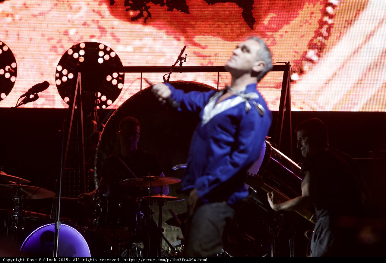 Morrissey Leaning Back Dramatically Blue Shirt Arm Out Drummer LED Drum Head Two Circular Lights Red Screen