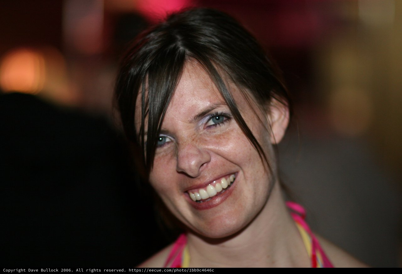 Radiant Smile at a Vibrant Evening Gathering