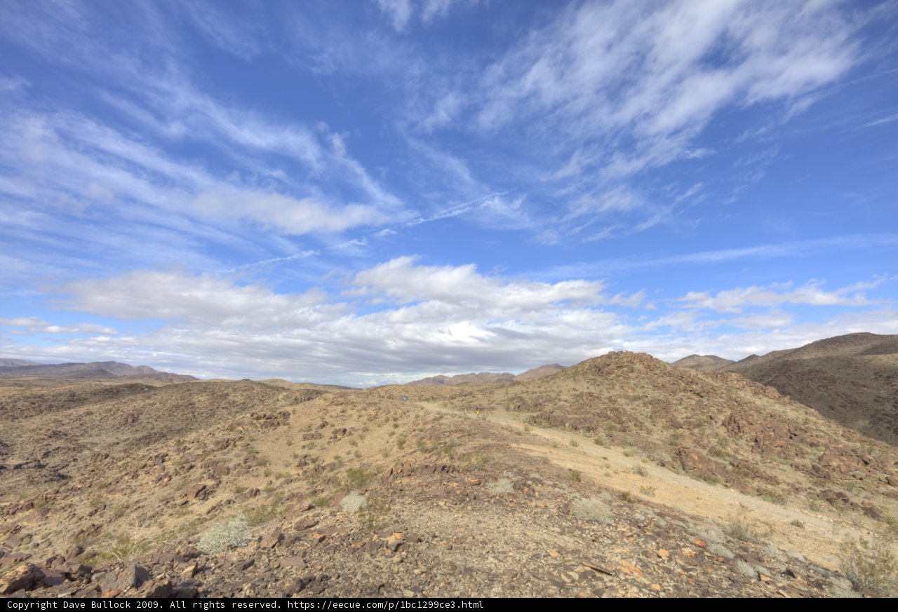 Majestic Mountain Range under a Blanket of Clouds