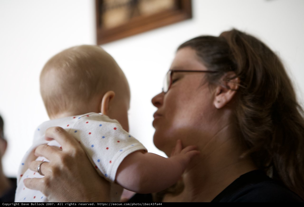 Mother's Tender Moment Lifting Baby With Love